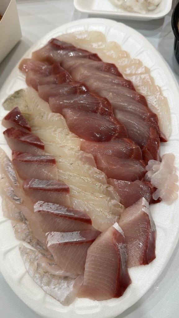 Sliced sashimi with red and white hues