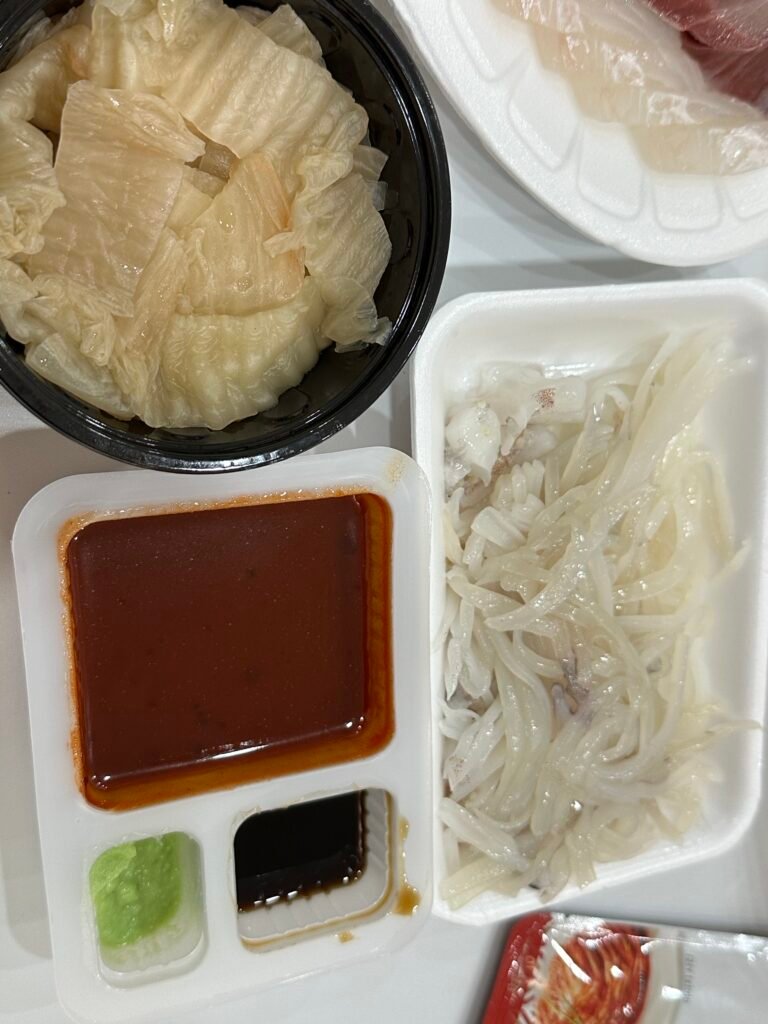Squid sashimi served with aged kimchi and cho-gochujang for dipping