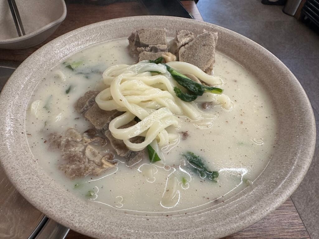 Bbyeokalguksu showcasing the knife-cut noodles in a milky white pork bone broth.