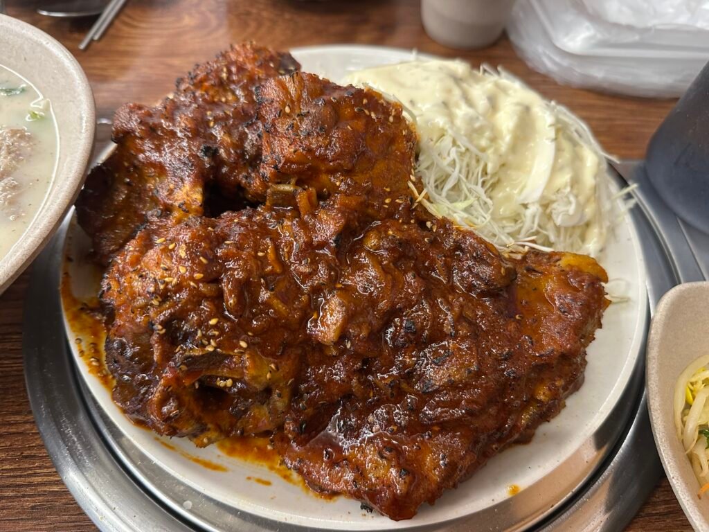 Grilled pork spine after torching, finished with a rich, smoky flavor.