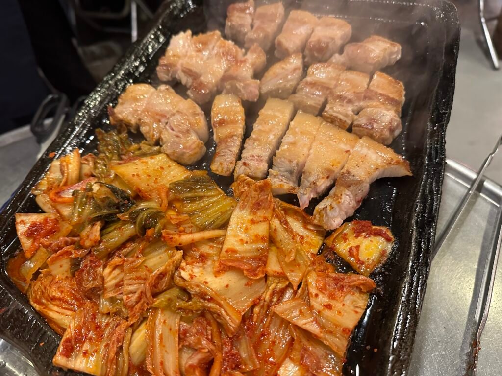 Golden-brown grilled pork cut into bite-sized pieces, ready to eat